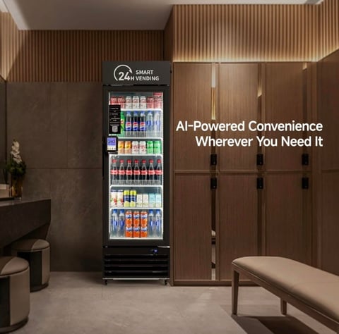 24-hour smart vending machine stocked with beverages and snacks in a modern locker room with wooden wall panels and benches